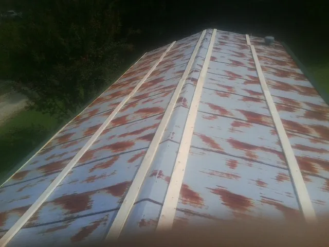 Rusted metal roof panels with new wood purlins before replacement — Storm Damage Roof Repair in Bryce by Roofing Brothers